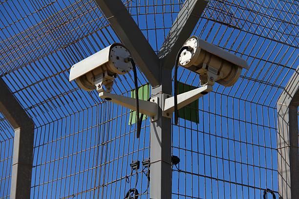 Industrial zone with security cameras on the blue sky background